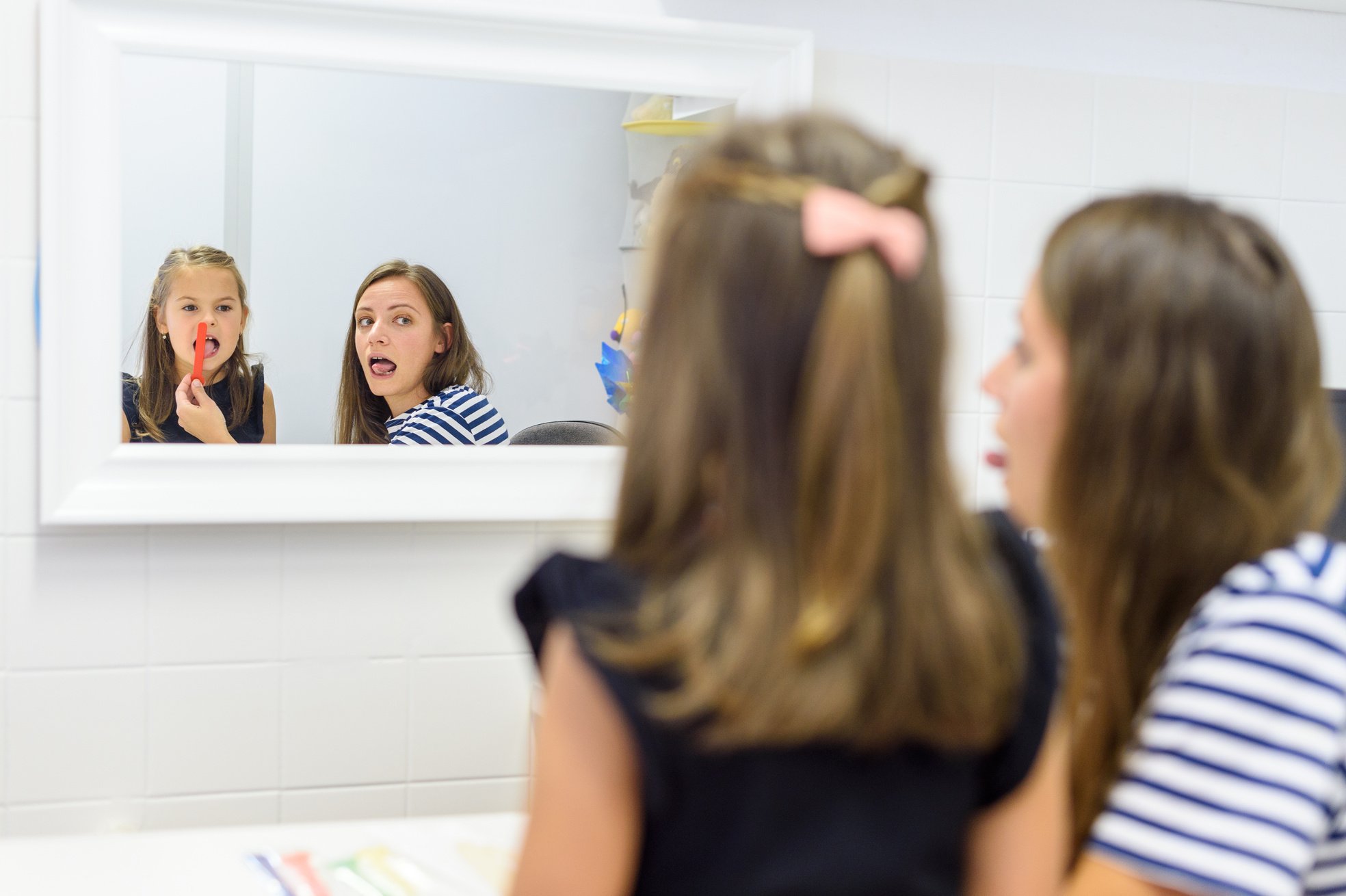 Children speech therapy concept. Preschooler practicing correct pronunciation with a female speech therapist.